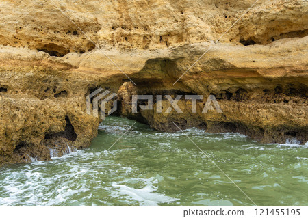 Majestic Coastal Cliffs and Sea Caves in Algarve, Portugal. 121455195