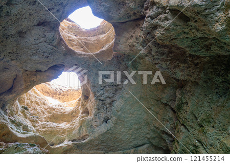 Sunlight Through the Algarve Sea Cave, Portugal at Dusk. 121455214
