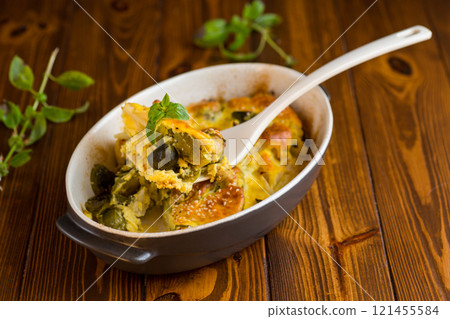 cauliflower and brussels sprouts casserole with cheese, in a ceramic dish on a wooden table cauliflower and brussels sprouts casserole with cheese, in a ceramic dish on a wooden table 121455584