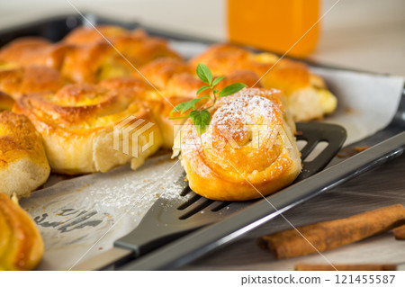 Pastries. Sweet buns with cottage cheese filling and honey in a plate on a wooden table Pastries. Sweet buns with cottage cheese filling and honey in a plate on a wooden table 121455587