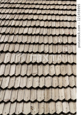 Old traditional wooden shingled roof pattern background, copy space 121456995