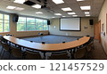 Modern conference room with large windows, projector, screen, and curved table. 121457529