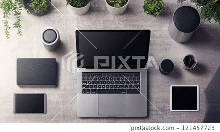 Laptop, tablet, speakers, and plants on a desk. Laptop, tablet, speakers, and plants on a desk. 121457723