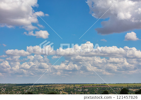 Majestic cotton candy clouds float lazily over a vast green landscape in bright daylight. Copy space. Majestic cotton candy clouds float lazily over a vast green landscape in bright daylight. Copy space. 121457826