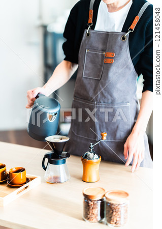 Young man making coffee, no face 121458048