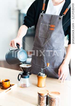 Young man making coffee, no face 121458049