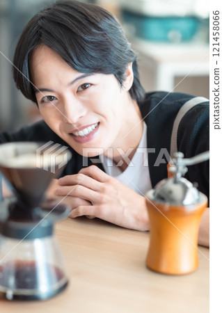 Portrait of a male barista enjoying coffee drip time Portrait of a male barista enjoying coffee drip time 121458066
