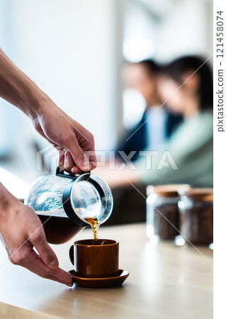 A calm cafe and a person brewing coffee, no face A calm cafe and a person brewing coffee, no face 121458074