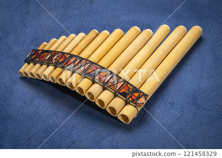 bamboo pan flute instrument from Peru against textured art paper bamboo pan flute instrument from Peru against textured art paper 121458329