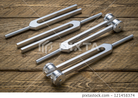 Set of weighted and unweighted metal tuning forks used for tuning musical instruments, sound therapy, chakra healing or relaxation. 121458374