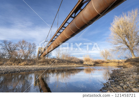 Old abandoned aqueduct suspended across the Poudre River in Fort Collins, Colorado - Great Western Sugar Company Effluent Flume and Bridge Old abandoned aqueduct suspended across the Poudre River in Fort Collins, Colorado - Great Western Sugar Company Effluent Flume and Bridge 121458721