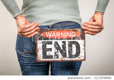 END Concept. Warning sign with text in woman's hands END Concept. Warning sign with text in woman's hands 121459660