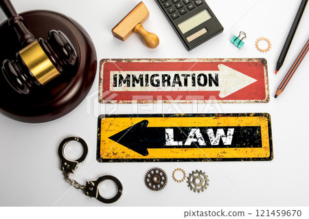 Immigration Law Concept. Two directional arrows on an office desk 121459670
