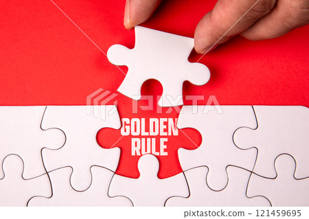 Golden Rule. White puzzle pieces on an red background 121459695