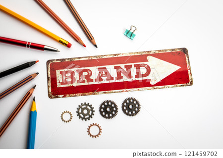 BRAND. Red sign on a white office desk 121459702