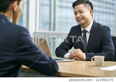 asian corporate executives discussing business in office 121462235