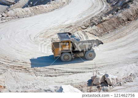 Big dumper carries ore in a marble quarry 121462756