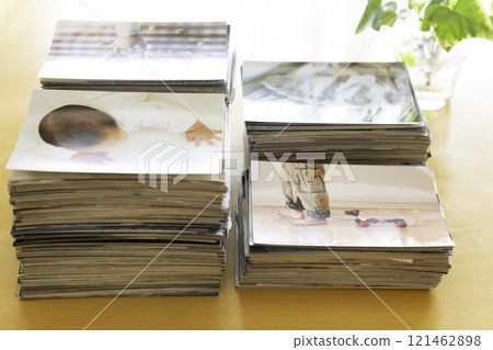 Many photo prints piled up on the table Many photo prints piled up on the table 121462898