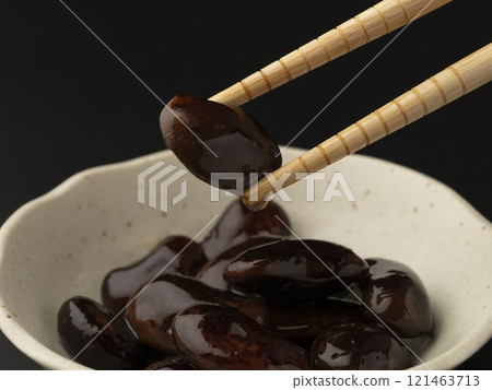 Picking up boiled beans with chopsticks 121463713