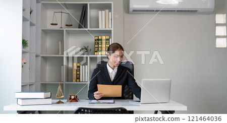 Lawyer Working in Organized Office with Justice Symbols 121464036