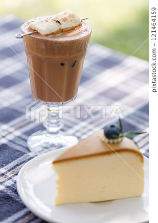 Cup of delicious chocolate with s'more marshmallows on checked pattern table 121464159