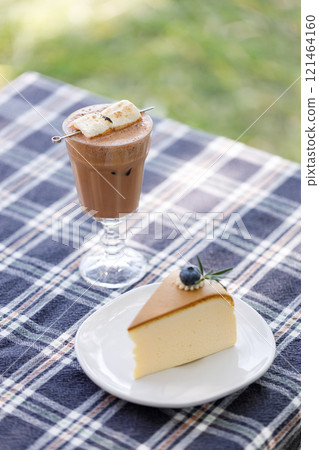 Cup of delicious chocolate with s'more marshmallows on checked pattern table 121464160
