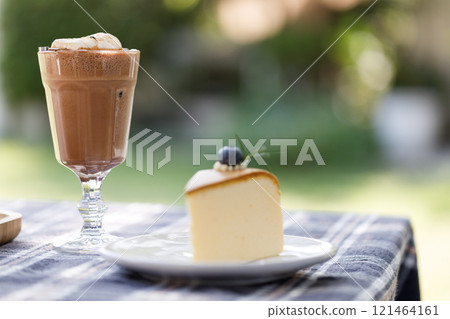 Cup of delicious chocolate with s'more marshmallows on checked pattern table 121464161