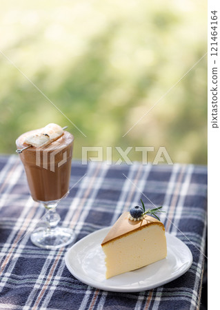 Cup of delicious chocolate with s'more marshmallows on checked pattern table Cup of delicious chocolate with s'more marshmallows on checked pattern table 121464164