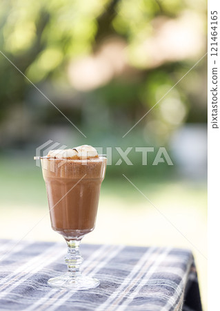 Cup of delicious chocolate with s'more marshmallows on checked pattern table Cup of delicious chocolate with s'more marshmallows on checked pattern table 121464165
