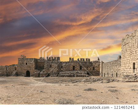 Ruins of Azraq Castle (Qasr al-Azraq) is a crusader castle (300AD), central-eastern Jordan, 100 km east of Amman, Jordan. Against the background of a beautiful sky with clouds Ruins of Azraq Castle (Qasr al-Azraq) is a crusader castle (300AD), central-eastern Jordan, 100 km east of Amman, Jordan. Against the background of a beautiful sky with clouds 121465241