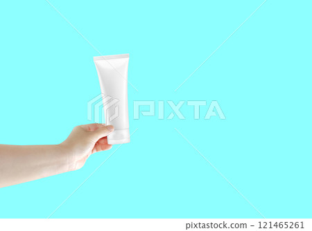 In the hand held tube empty white cosmetic foam tube. 121465261