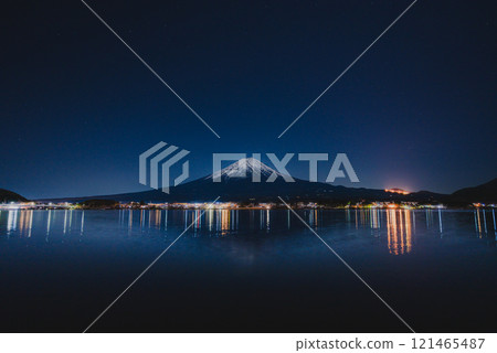 Mount Fuji at night with a beautiful starry sky and reflection on the lake surface Mount Fuji at night with a beautiful starry sky and reflection on the lake surface 121465487
