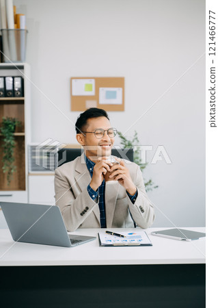 Businessman executive manager looking at laptop watching online webinar training or having virtual meeting video conference doing market research working Businessman executive manager looking at laptop watching online webinar training or having virtual meeting video conference doing market research working 121466777