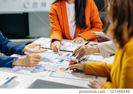 Businessman and team analyzing financial statement Finance task. with smart phone and laptop and  tablet. 121466846