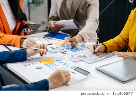 Businessman and team analyzing financial statement Finance task. with smart phone and laptop and  tablet. 121466847
