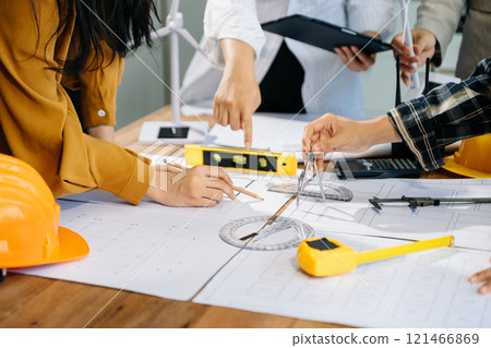 Creative architect projecting on the big drawings with architectural project 121466869