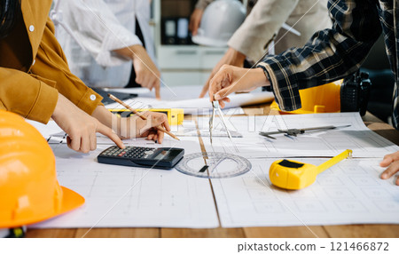 Creative architect projecting on the big drawings with architectural project Creative architect projecting on the big drawings with architectural project 121466872