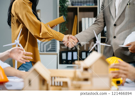 Engineer desk with object paper and tablet with blurry engineer teamwork hardworking Engineer desk with object paper and tablet with blurry engineer teamwork hardworking 121466894