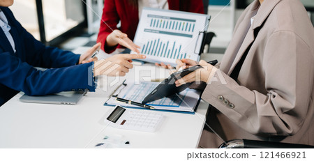 Business team meeting present.professional investor working with Finance managers task. with laptop smart phone and digital tablet Business team meeting present.professional investor working with Finance managers task. with laptop smart phone and digital tablet 121466921