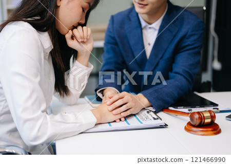 Judge gavel with scales of justice, Business and lawyer or counselor consulting and discussing contract papers with laptop and tablet at law firm 121466990