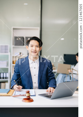 Asian man lawyer working and gavel, tablet, laptop in front, Advice justice and law concept. Asian man lawyer working and gavel, tablet, laptop in front, Advice justice and law concept. 121467005