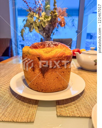 Freshly Baked Panettone on a Plate with a Cozy Indoor Winter Background. High quality photo Freshly Baked Panettone on a Plate with a Cozy Indoor Winter Background. High quality photo 121467017