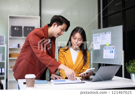 Portrait of success business people working together in office. Couple teamwork startup concept Portrait of success business people working together in office. Couple teamwork startup concept 121467025