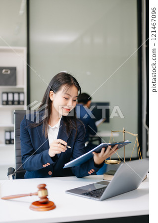 Asian woman lawyer working and gavel, tablet, laptop in front, Advice justice and law concept. 121467096