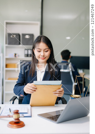 Asian woman lawyer working and gavel, tablet, laptop in front, Advice justice and law concept. 121467249
