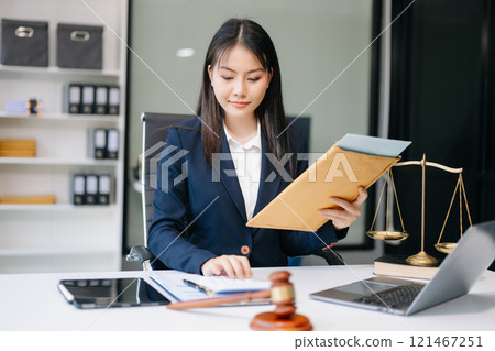 Asian woman lawyer working and gavel, tablet, laptop in front, Advice justice and law concept. 121467251