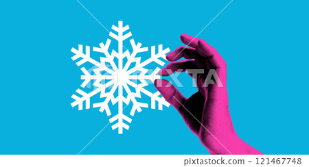 Contemporary art collage. Pink hand delicately pinches snowflake against vibrant blue background. Festive mood. 121467748