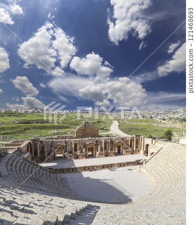 Amphitheater in Jerash (Gerasa of Antiquity), capital and largest city of Jerash Governorate, Jordan. Against the background of a beautiful sky with clouds 121468693