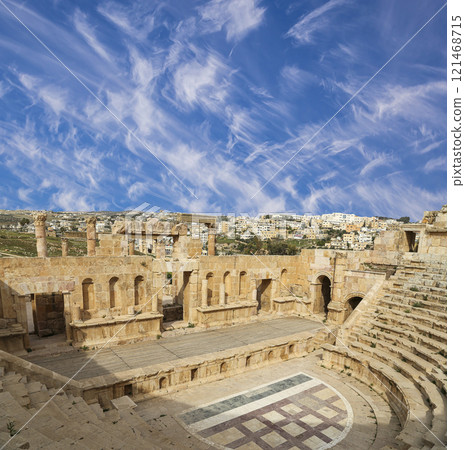 Amphitheater in Jerash (Gerasa of Antiquity), capital and largest city of Jerash Governorate, Jordan. Against the background of a beautiful sky with clouds 121468715