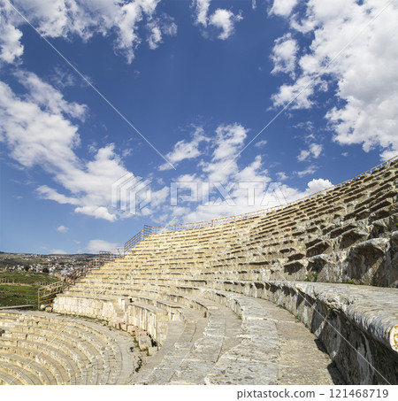 Amphitheater in Jerash (Gerasa of Antiquity), capital and largest city of Jerash Governorate, Jordan. Against the background of a beautiful sky with clouds Amphitheater in Jerash (Gerasa of Antiquity), capital and largest city of Jerash Governorate, Jordan. Against the background of a beautiful sky with clouds 121468719